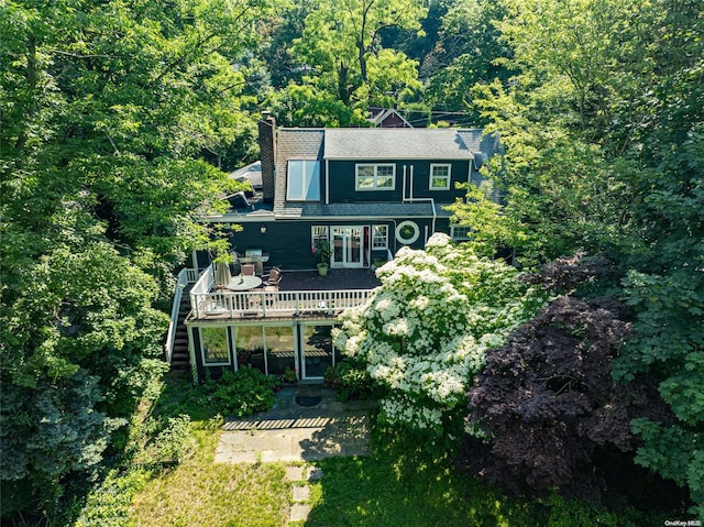 90 E Broadway, Roslyn, NY 11576 - rear view of property with a wooden deck, stairs, a chimney, and a forest view
