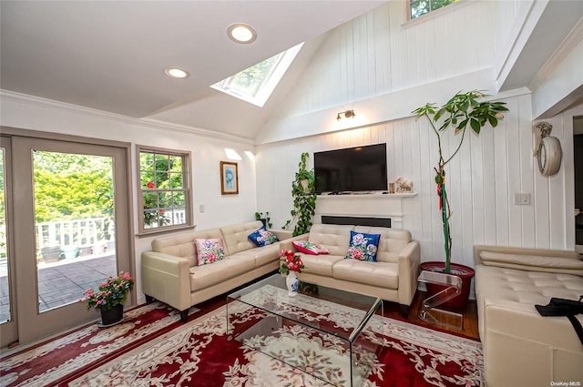 living room featuring plenty of natural light, wood-type flooring, ornamental molding, and a skylight