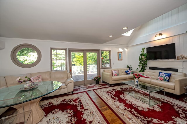 living room with hardwood / wood-style floors, lofted ceiling, and crown molding