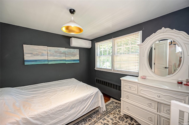 bedroom with a wall unit AC and radiator