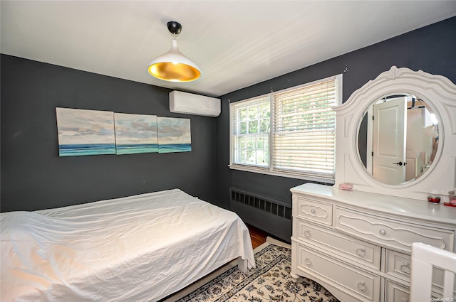 90 E Broadway, Roslyn, NY 11576 - bedroom featuring radiator, a wall mounted AC, and light wood finished floors