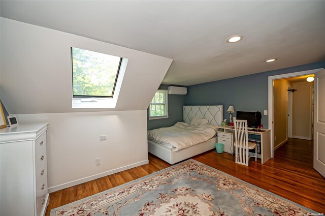90 E Broadway, Roslyn, NY 11576 - bedroom featuring wood finished floors, recessed lighting, a skylight, baseboards, and an AC wall unit