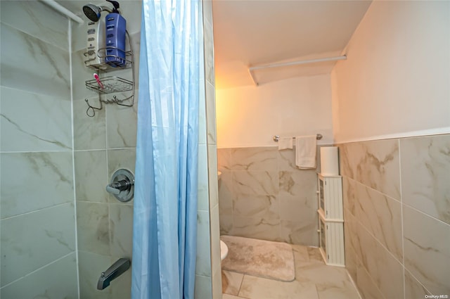 bathroom featuring curtained shower and tile walls