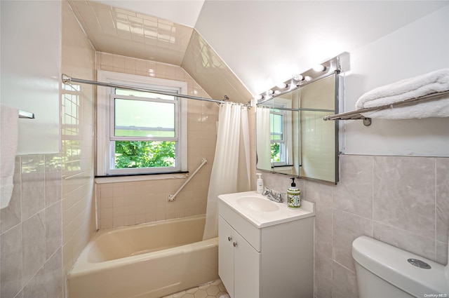 full bathroom with vanity, tile patterned floors, toilet, tile walls, and shower / tub combo