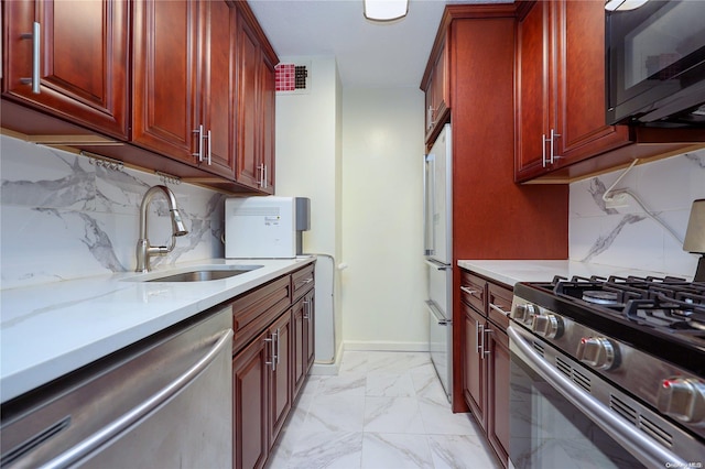 kitchen featuring tasteful backsplash, sink, and stainless steel appliances