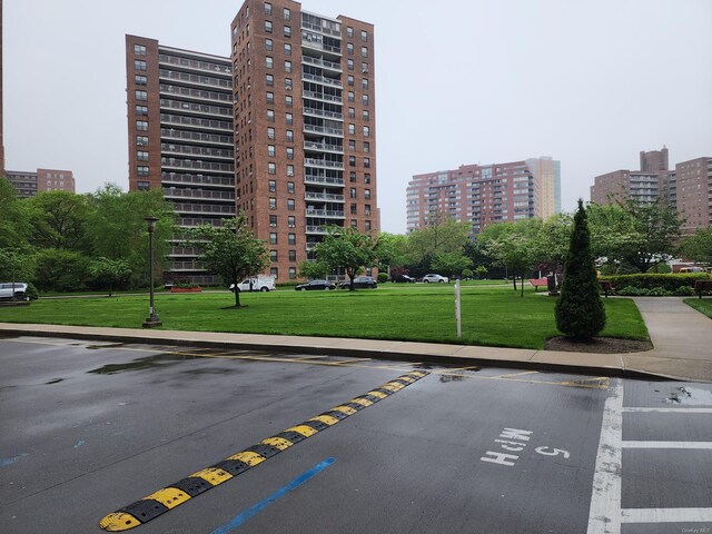 view of building exterior with a view of city and uncovered parking