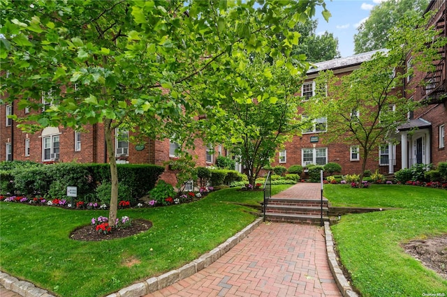 view of property's community with a lawn