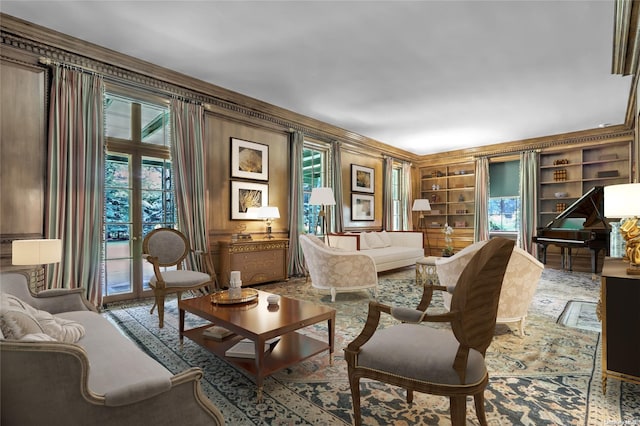 sitting room featuring crown molding, built in features, and plenty of natural light