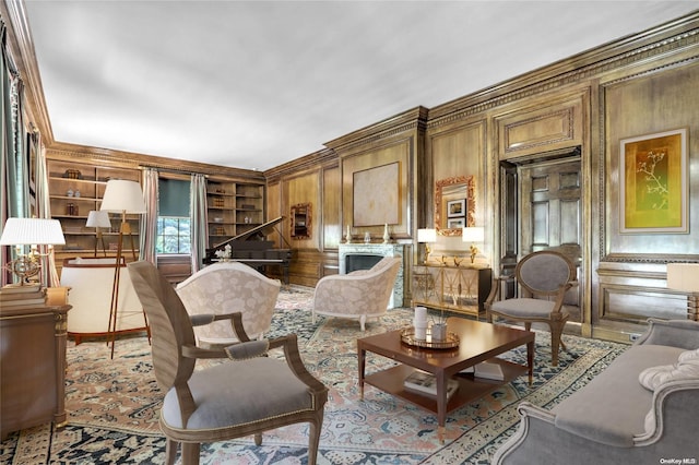 sitting room with built in shelves, ornamental molding, and wooden walls