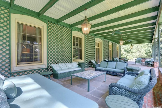 view of patio with an outdoor living space and ceiling fan