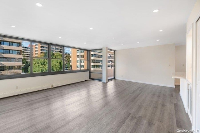 unfurnished living room with wood-type flooring