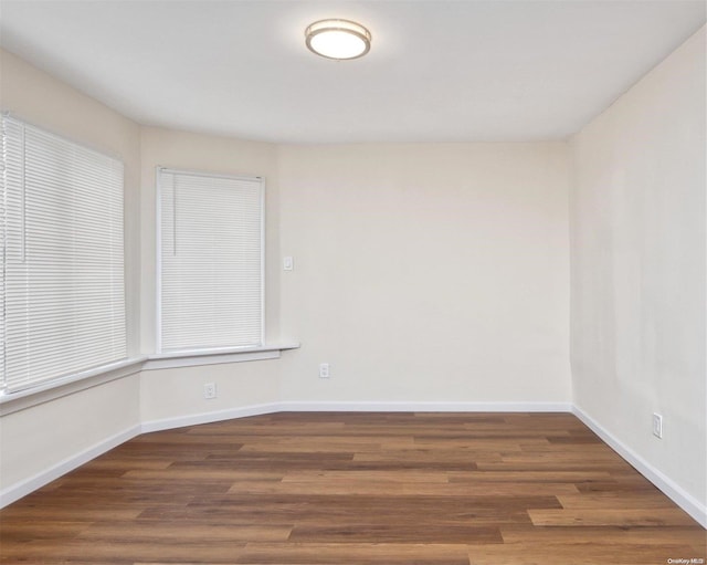 spare room featuring dark hardwood / wood-style floors