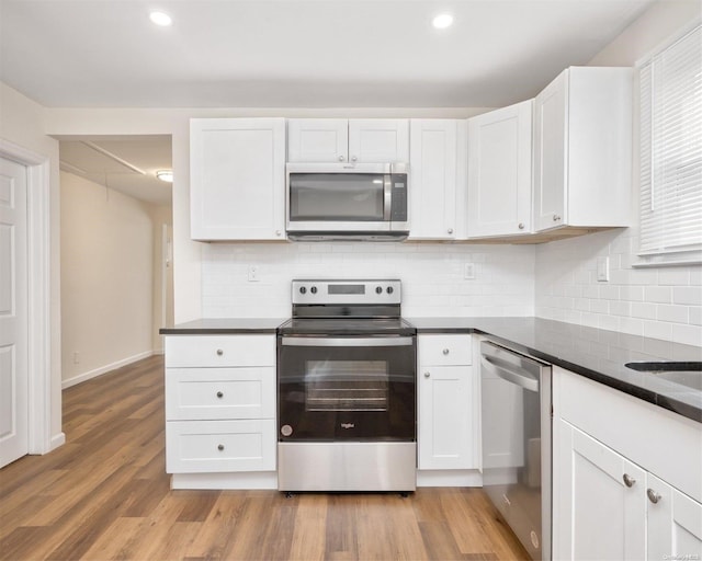 kitchen with white cabinetry and appliances with stainless steel finishes