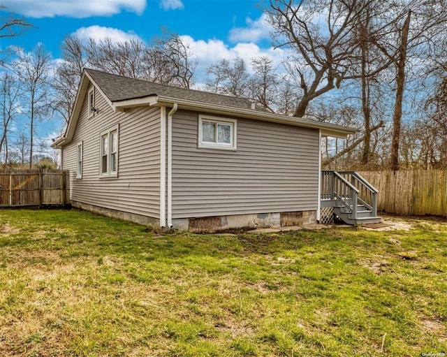 view of side of home with a yard