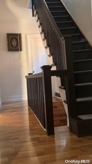 stairs featuring wood-type flooring