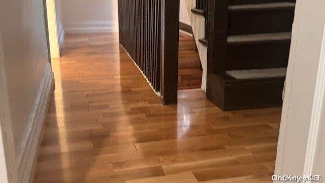 hallway with hardwood / wood-style flooring