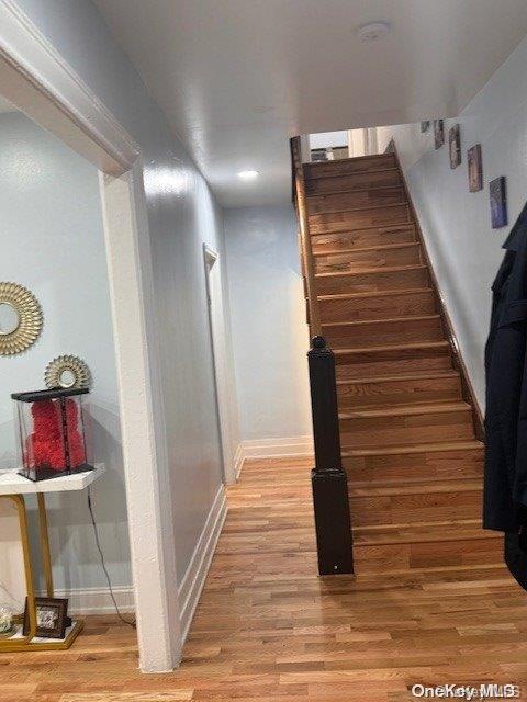 stairway featuring wood-type flooring