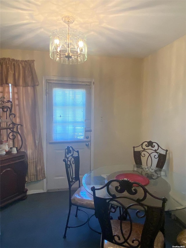 carpeted dining room featuring an inviting chandelier