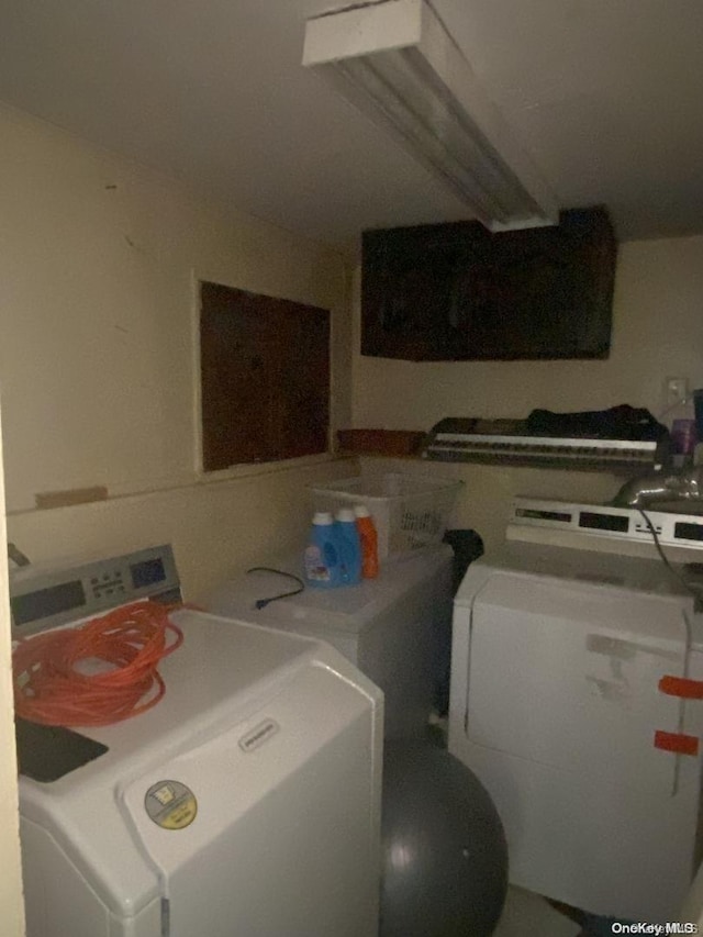 clothes washing area featuring independent washer and dryer