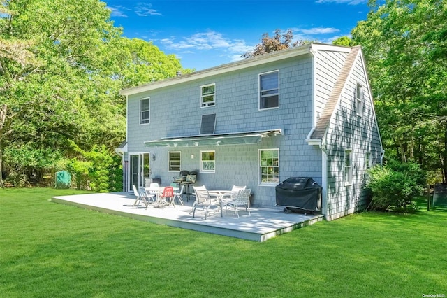 back of property featuring a yard and a patio area