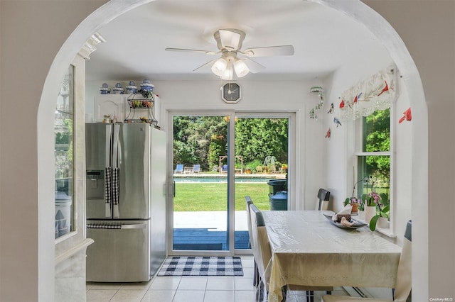 doorway to outside with light tile patterned floors and ceiling fan