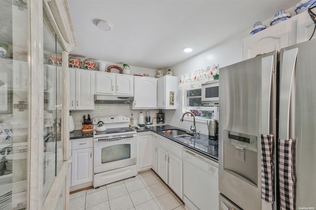 kitchen with light tile patterned floors, white appliances, white cabinetry, and sink