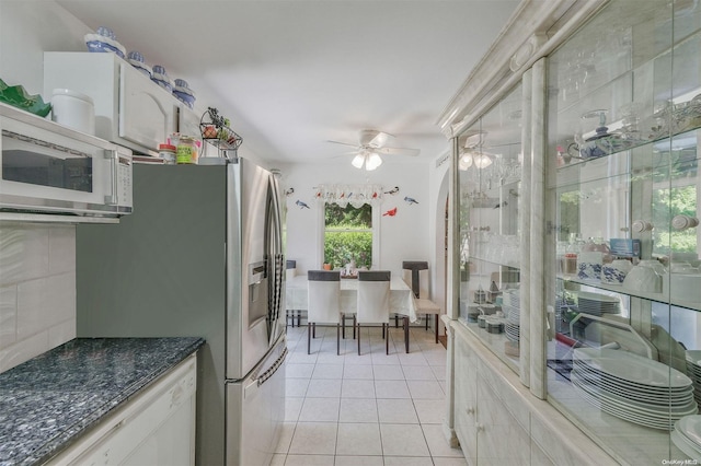 kitchen with white cabinetry, ceiling fan, a healthy amount of sunlight, and light tile patterned flooring