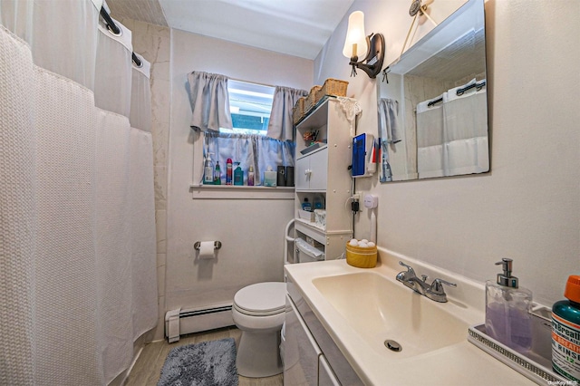 bathroom with hardwood / wood-style flooring, vanity, toilet, and a baseboard heating unit