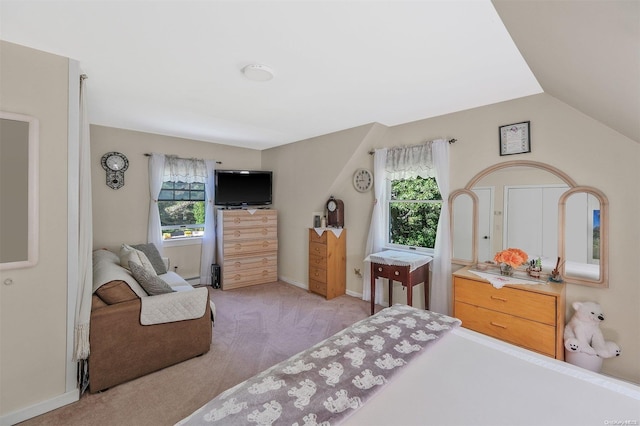 carpeted bedroom with vaulted ceiling and multiple windows