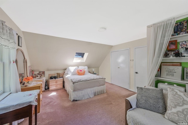 bedroom with carpet flooring and vaulted ceiling with skylight