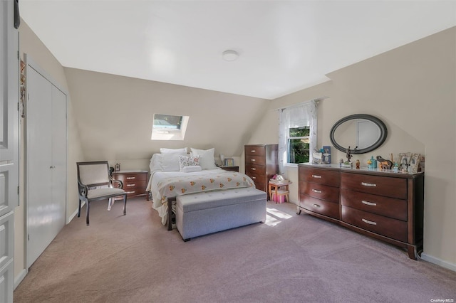 bedroom with lofted ceiling and light carpet