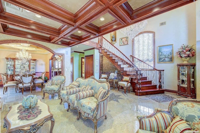 living room with beamed ceiling, an inviting chandelier, crown molding, and coffered ceiling