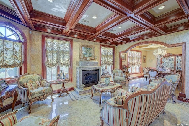 living room featuring beamed ceiling, crown molding, a wealth of natural light, and coffered ceiling