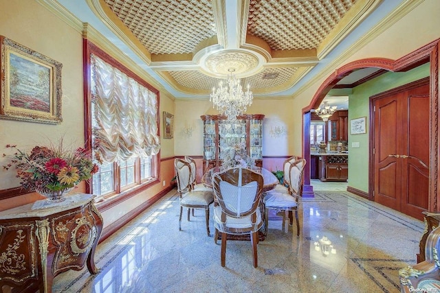 dining room featuring a notable chandelier, crown molding, and coffered ceiling