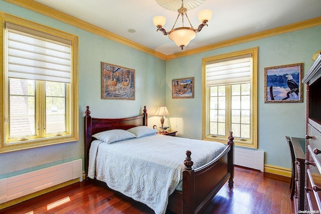 bedroom featuring a chandelier, dark wood-type flooring, a baseboard heating unit, and ornamental molding