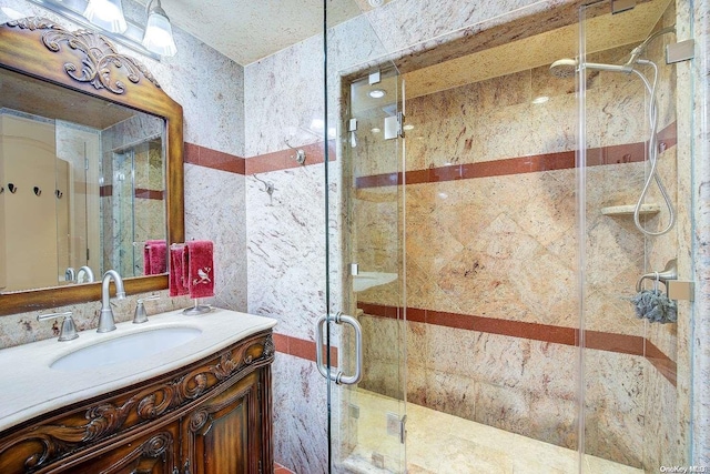 bathroom with vanity and a shower with shower door