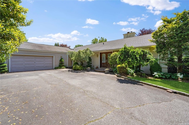 single story home featuring french doors and a garage