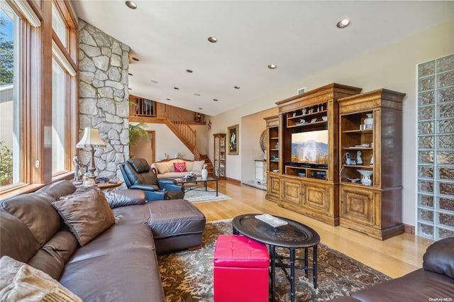 living room featuring light hardwood / wood-style floors and lofted ceiling