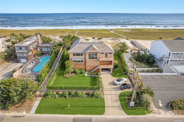 drone / aerial view with a beach view and a water view