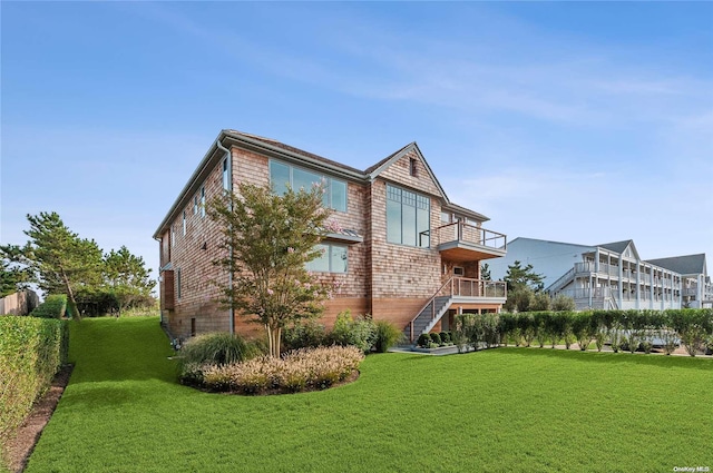 view of home's exterior with a lawn and a balcony