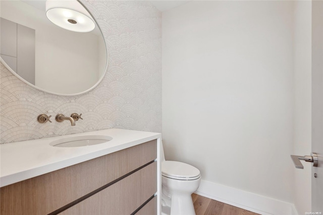 451 Dune Rd, Westhampton Beach, NY 11978 - bathroom with wallpapered walls, baseboards, vanity, toilet, and wood finished floors