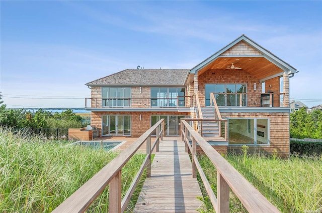 451 Dune Rd, Westhampton Beach, NY 11978 - back of property with a balcony, ceiling fan, and stairs
