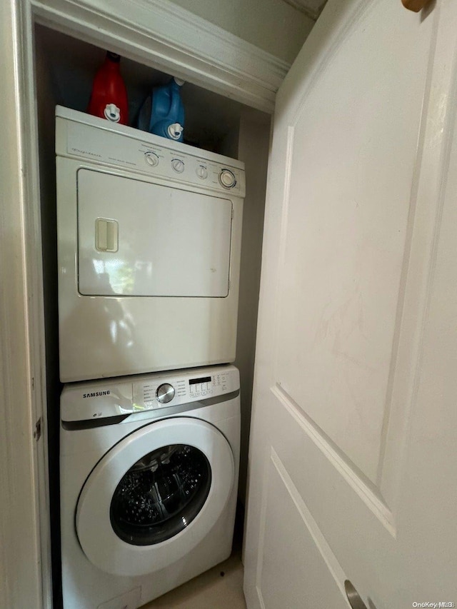 washroom with stacked washer and dryer