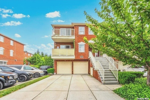 view of property with a garage and a balcony