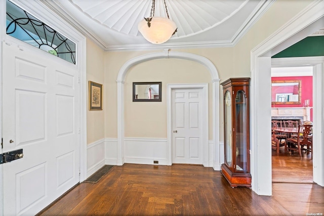 entrance foyer with dark wood-type flooring and ornamental molding