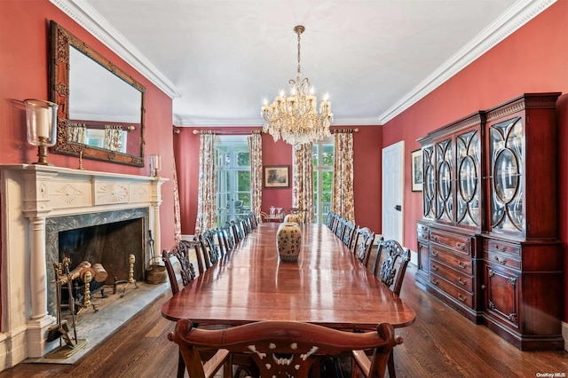 dining area featuring dark hardwood / wood-style flooring, a premium fireplace, crown molding, and an inviting chandelier