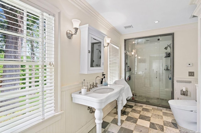 bathroom with crown molding, toilet, and walk in shower