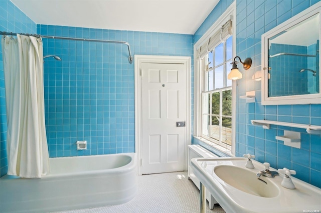 bathroom featuring tile patterned flooring, shower / bath combination with curtain, and tile walls