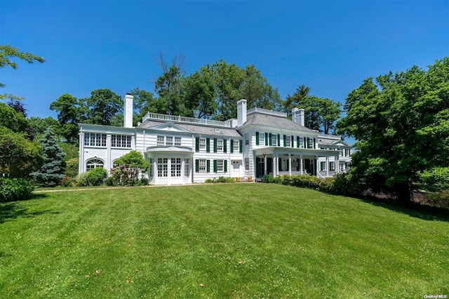 back of property featuring french doors and a yard