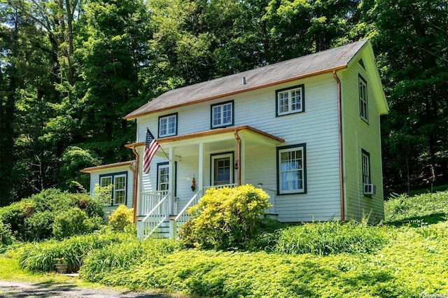 view of front of house featuring cooling unit and covered porch